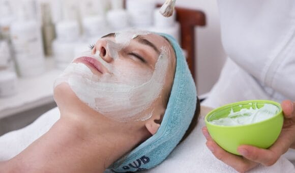 woman having facial spa treatment