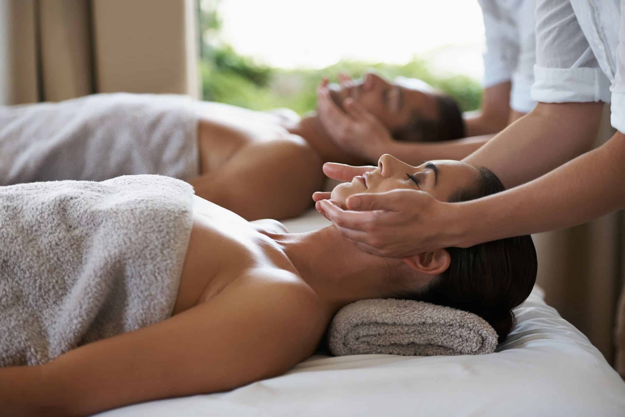 Man and woman on massage bed relaxing with neck massage